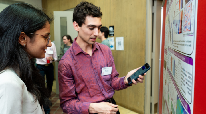 Students presenting research during graduate research symposium