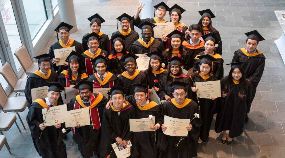 student and faculty members dressed in regalia during commencement