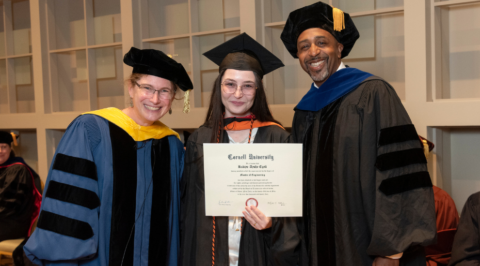 student and faculty members dressed in regalia during commencement